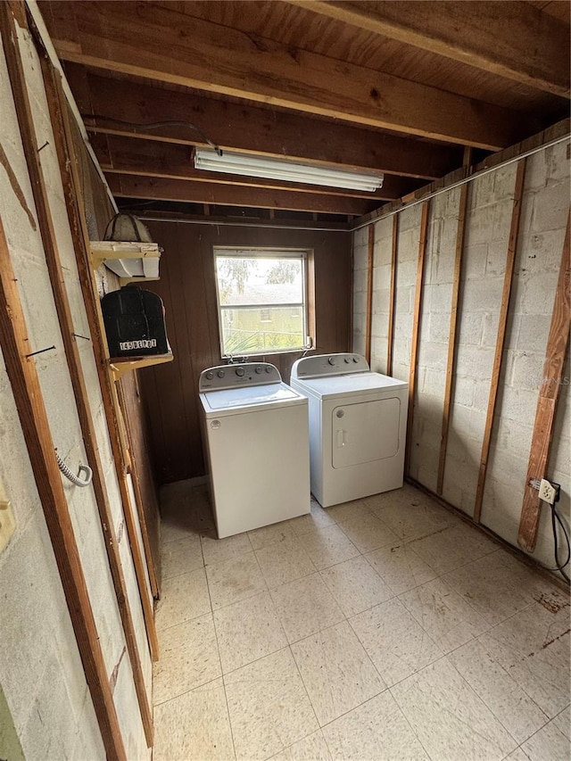 washroom with laundry area, light floors, and independent washer and dryer