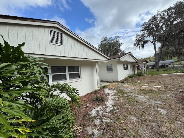 view of property exterior featuring fence and concrete block siding