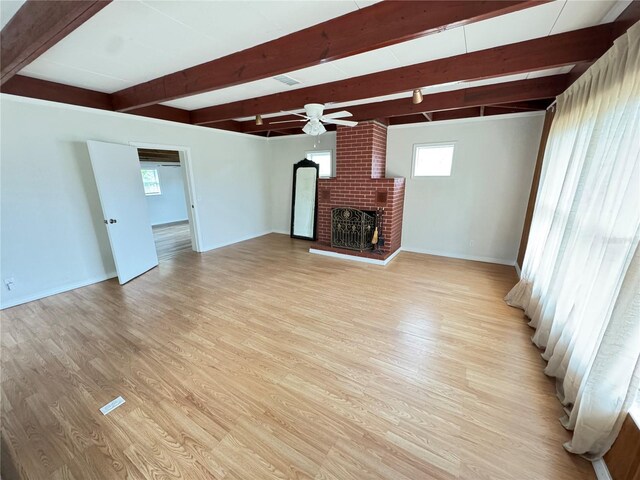 unfurnished living room with light wood finished floors, beamed ceiling, a ceiling fan, and baseboards