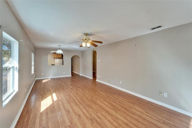 unfurnished living room with ceiling fan and light wood-type flooring