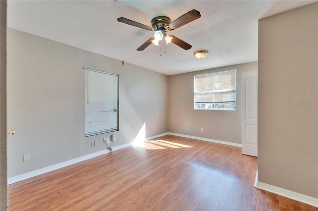 spare room with light wood-type flooring and ceiling fan