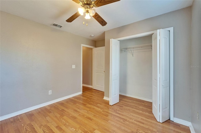 unfurnished bedroom with ceiling fan, light hardwood / wood-style flooring, and a closet