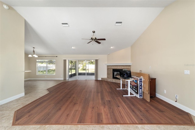 unfurnished living room with a ceiling fan, visible vents, and baseboards