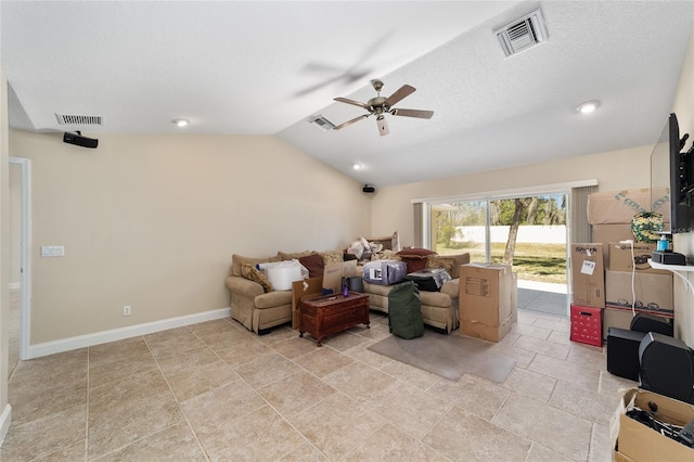 living room with lofted ceiling, ceiling fan, visible vents, and baseboards