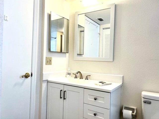 bathroom featuring toilet and vanity