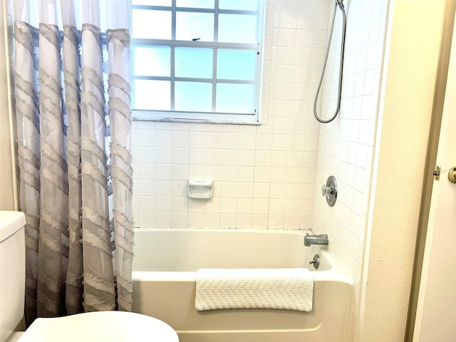 bathroom with toilet and shower / bath combination with curtain