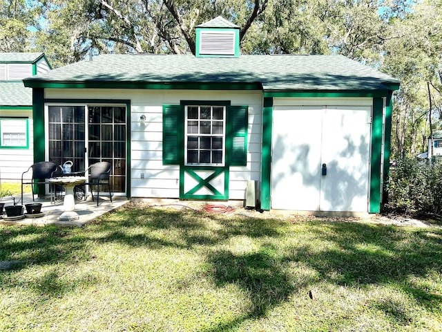 view of outdoor structure featuring a lawn