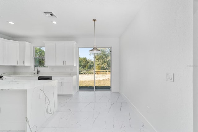 kitchen featuring light stone counters, marble finish floor, visible vents, white cabinets, and baseboards