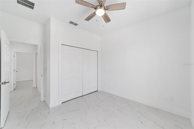 unfurnished bedroom featuring marble finish floor, visible vents, and baseboards