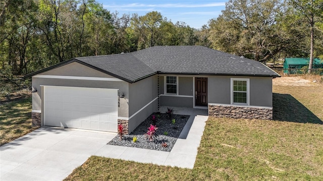 ranch-style home with an attached garage, stone siding, driveway, and stucco siding