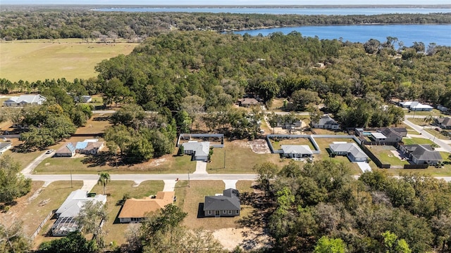 birds eye view of property with a water view, a forest view, and a residential view