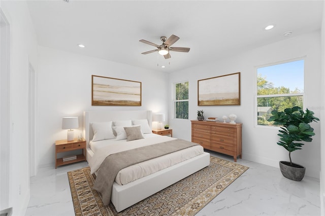 bedroom with baseboards, marble finish floor, and recessed lighting