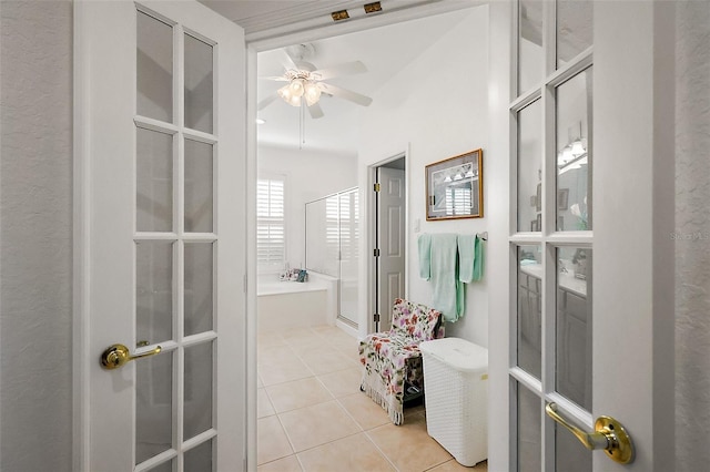 bathroom with a shower with shower door, a garden tub, ceiling fan, and tile patterned floors