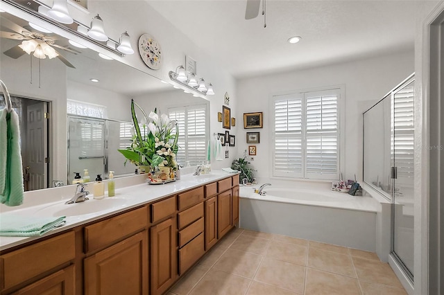 bathroom with tile patterned flooring, ceiling fan, and a sink