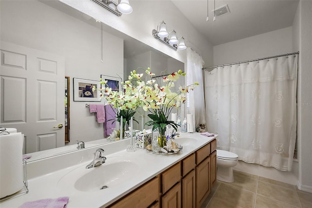 bathroom featuring toilet, shower / tub combo, tile patterned flooring, and a sink