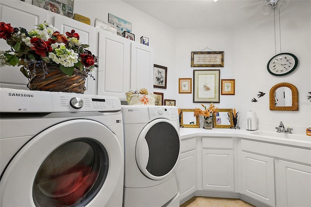 laundry room with light tile patterned floors, washing machine and dryer, cabinet space, and a sink