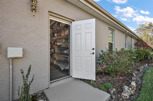 property entrance with stucco siding