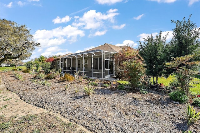 back of property with a sunroom