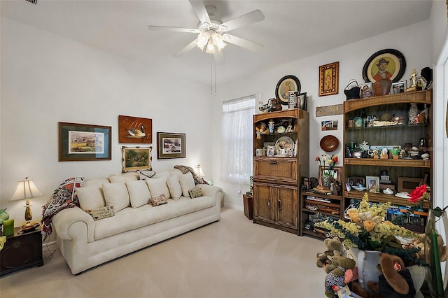 living area with carpet floors and a ceiling fan