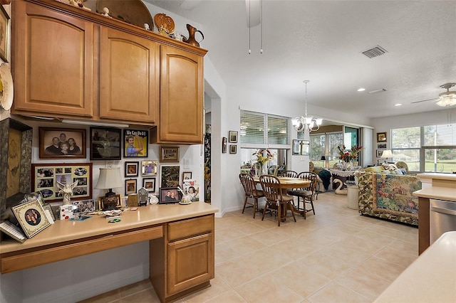 kitchen with ceiling fan with notable chandelier, visible vents, light countertops, built in study area, and dishwasher