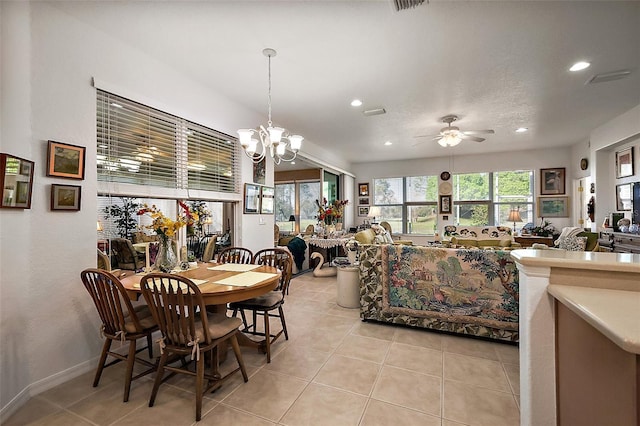 dining space with light tile patterned floors, recessed lighting, a textured ceiling, and ceiling fan with notable chandelier