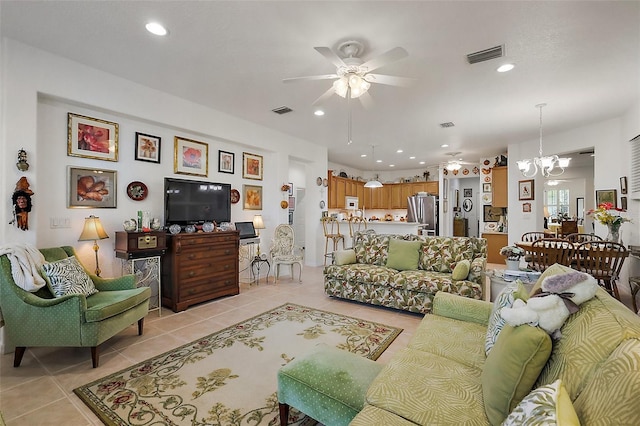 living area featuring ceiling fan with notable chandelier, visible vents, recessed lighting, and light tile patterned floors