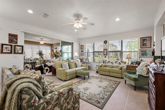 living area featuring ceiling fan, light tile patterned flooring, visible vents, and recessed lighting