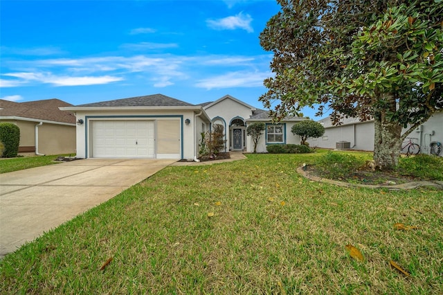 ranch-style home featuring a garage, cooling unit, and a front yard