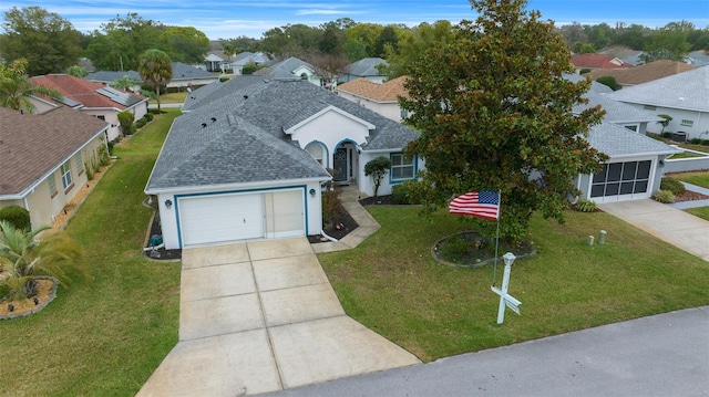 view of front of home featuring a front yard and a garage