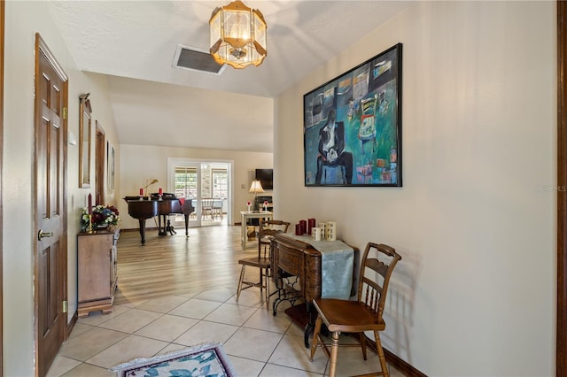 interior space with visible vents, a notable chandelier, baseboards, and light tile patterned floors