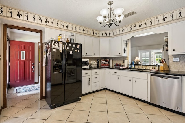 kitchen featuring white microwave, a sink, black fridge with ice dispenser, visible vents, and dishwasher