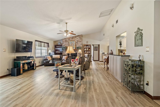 living area with ceiling fan, light wood-style flooring, visible vents, and baseboards