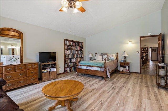 bedroom with light wood-type flooring, lofted ceiling, ceiling fan, and baseboards