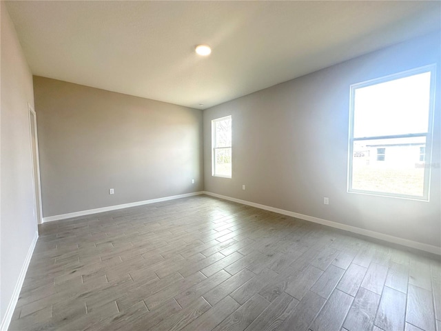 unfurnished room with light hardwood / wood-style flooring