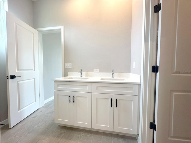 bathroom with hardwood / wood-style floors and vanity