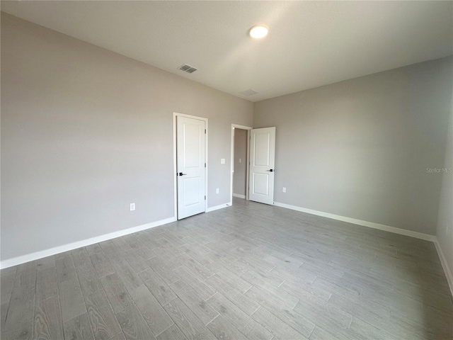 unfurnished room featuring light wood-type flooring