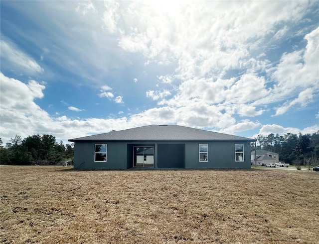 back of house with a yard