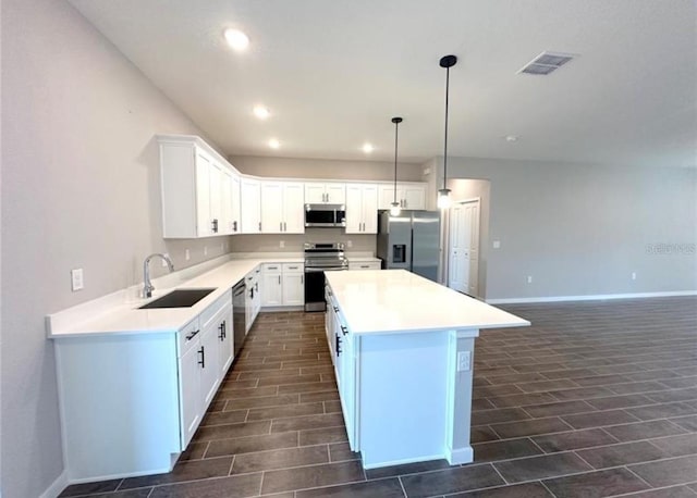 4501 SW 110th Ln, Ocala, FL 34476 - kitchen with appliances with stainless steel finishes, a center island, white cabinetry, recessed lighting, and light countertops