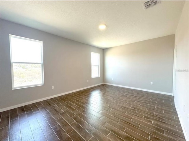 4501 SW 110th Ln, Ocala, FL 34476 - spare room with dark wood-style flooring and a textured ceiling