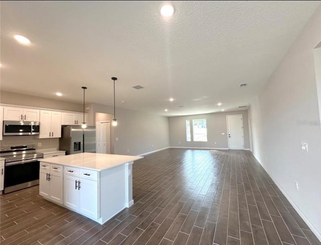 4501 SW 110th Ln, Ocala, FL 34476 - kitchen with stainless steel appliances, dark wood-style floors, white cabinetry, a center island, and recessed lighting
