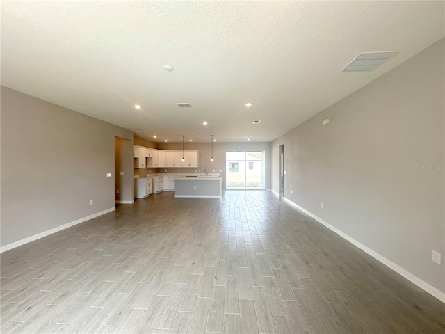 4501 SW 110th Ln, Ocala, FL 34476 - unfurnished living room featuring light wood-style flooring and recessed lighting