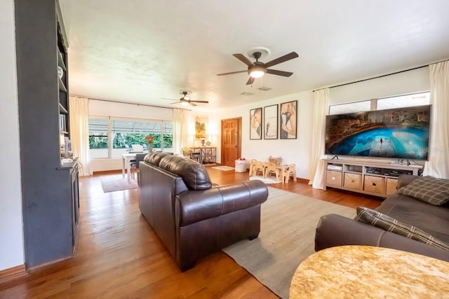 living room with ceiling fan and hardwood / wood-style floors