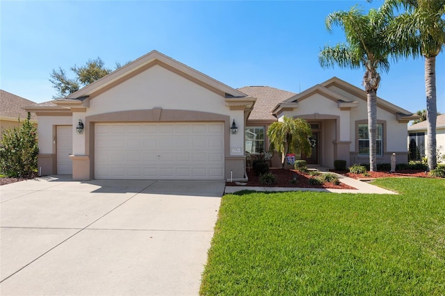 single story home featuring a garage, a front yard, driveway, and stucco siding