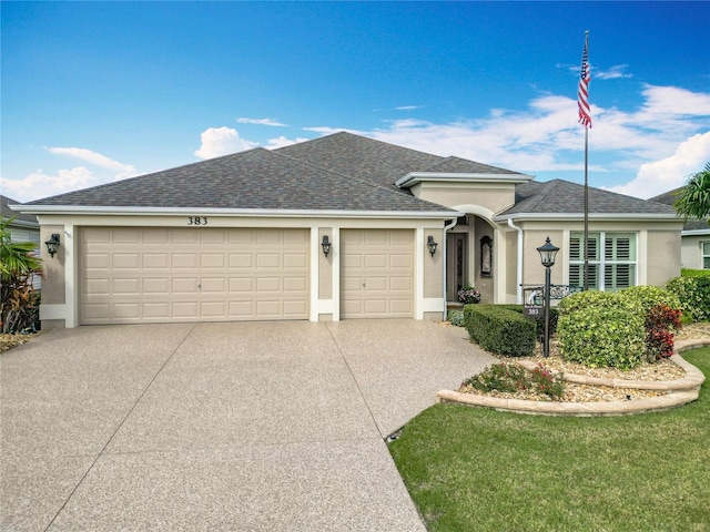 ranch-style house with an attached garage, concrete driveway, and stucco siding