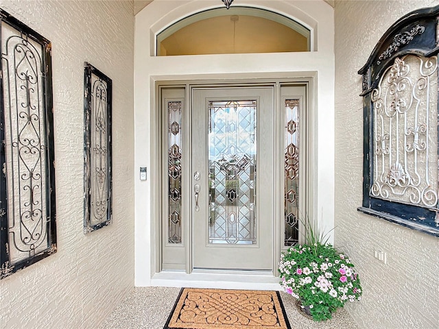 entrance to property featuring stucco siding