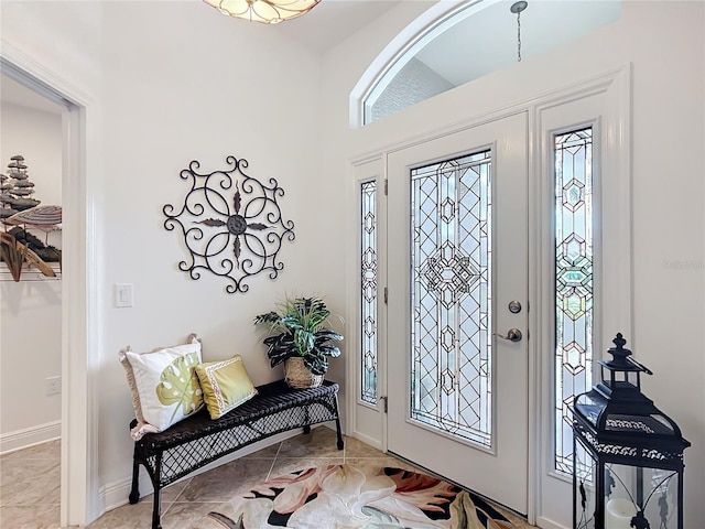 entryway featuring baseboards and light tile patterned floors