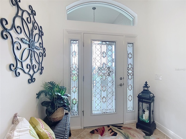 foyer entrance featuring baseboards and light tile patterned floors