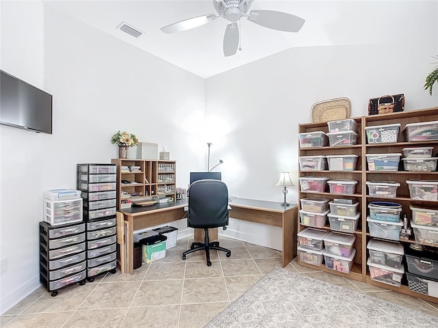 tiled office space featuring vaulted ceiling, baseboards, visible vents, and a ceiling fan