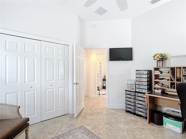 home office featuring visible vents, ceiling fan, baseboards, and light tile patterned floors