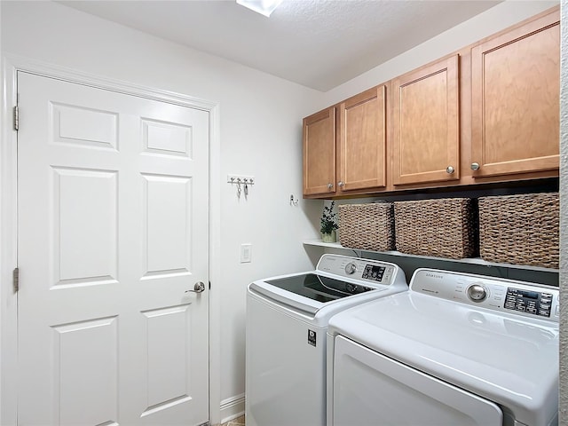 laundry area with cabinet space and washer and clothes dryer